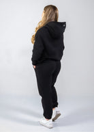 Woman wearing Midnight Black Nexarina sweatpants from the back