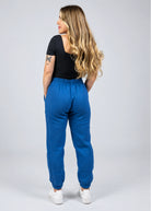 Back view of the women's Willow Sweatpants in Dusty Blue showing the relaxed fit, waistband and cuffed ankles.