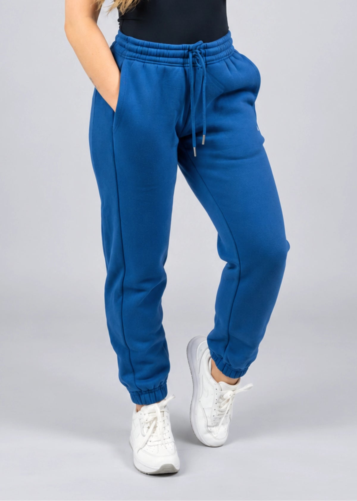 Close-up front view of the Willow women's sweatpants in Dusty Blue showing the waistband, drawcord, pockets and leg shape.